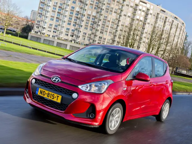 De vernieuwde Hyundai i10 rijdt door de straat.