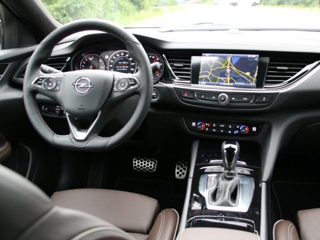 Het interieur van de Opel Insignia Grand Sport 1.5 Turbo met lederen stoelen en een dashboard.