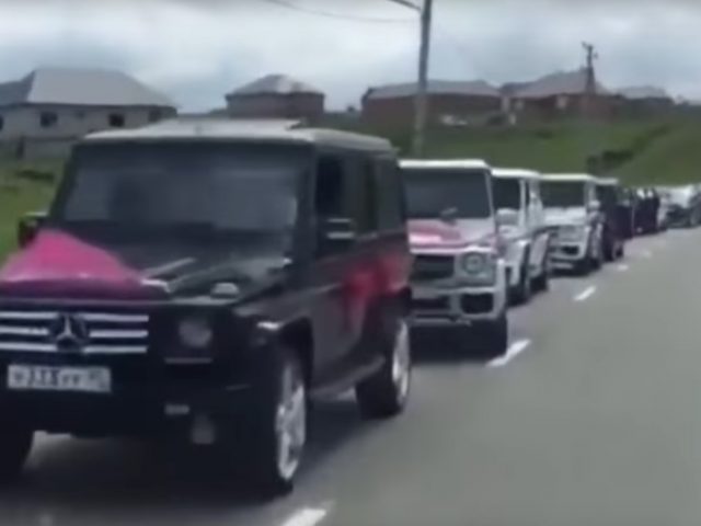 Een groep Mercedes-Benz GL-Klasse voertuigen staat opgesteld op de weg in een Tsjetsjeense trouwstoet.