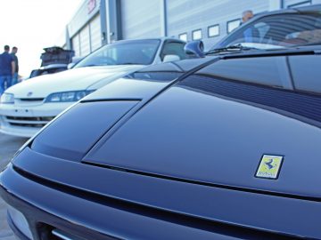 Een zwarte Ferrari-sportwagen geparkeerd in een garage tijdens de Borderrun Fly-in Car Show 2017.
