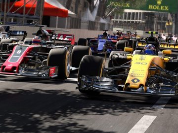 Een groep F1 2017-raceauto's die door een straat rijden.