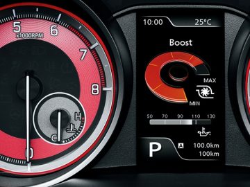 Het dashboard van een Suzuki Swift Sport met rode en zwarte meters, met extra details.