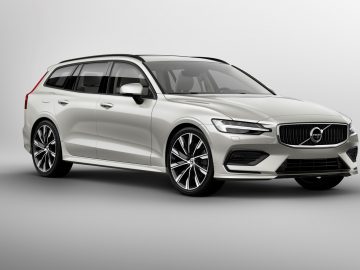 De Volvo V60-wagen wordt weergegeven op een grijze achtergrond.