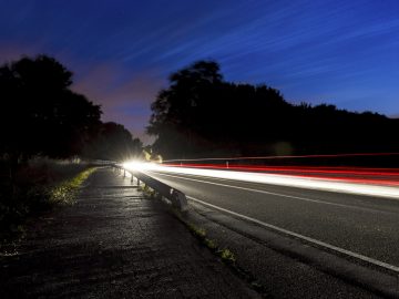 Car light trails on road at blue hour