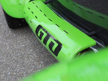 Een close-up van een groene Donkervoort-auto met zwarte letters.