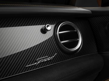 Het interieur van een Bentley Bentayga Speed met een koolstofvezel deurpaneel.