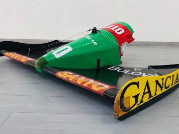 Een Halmo-model van een raceauto zittend op de vloer.