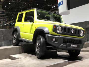 De Suzuki Jimny is naast Toyota-modellen te zien op een autoshow.