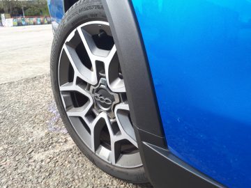 Een close-up van het stuur van een blauwe Fiat 500X Opening Edition-auto.