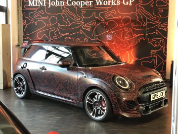Een MINI John Cooper Works GP geparkeerd in een showroom.