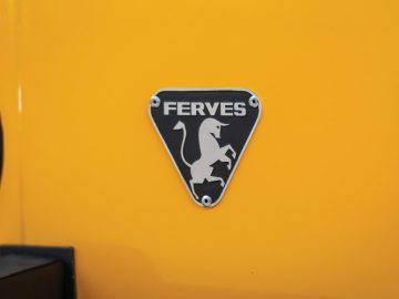 Ferves-embleem op de voorkant van een gele cabrioletjeep.