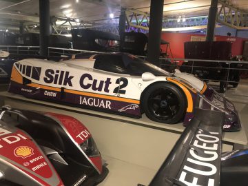 In een museum staat een Le Mans-raceauto tentoongesteld.