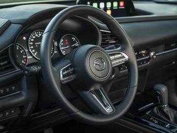 Het dashboard en het stuur van de Mazda 3 uit 2019.