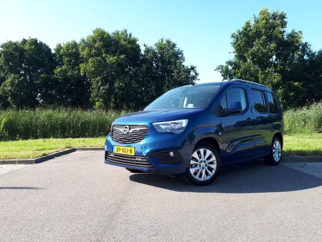 Een blauwe Opel Combo Tour geparkeerd langs de kant van de weg.