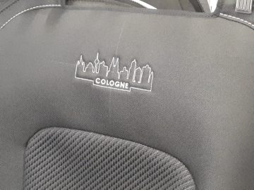 De achterbank van een zwarte Ford-auto met een wit logo erop.
