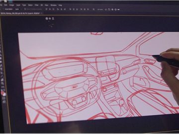 Een man tekent een Ford-ontwerp op een computerscherm.