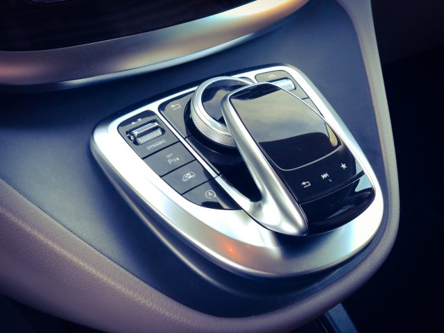 Een afbeelding van een Mercedes-Benz V-Klasse met een telefoon op het stuur.