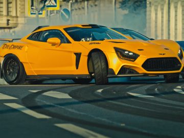 Een gele sportwagen die door een straat rijdt waar rook uit komt, versierd met het logo van The Evil Empire.