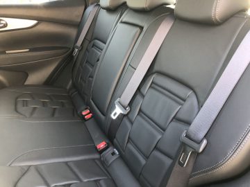 Nissan Qashqai zwart lederen autostoelen met veiligheidsgordels in het interieur van een voertuig.