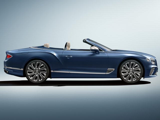 Blauwe Bentley Continental GT Mulliner Convertible op een neutrale achtergrond.