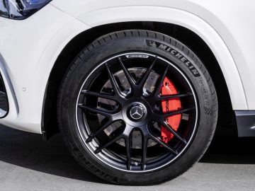 Close-up van een Mercedes-AMG-autowiel met Michelin-band en rode remklauw.