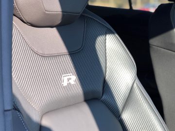 Geperforeerd lederen Volkswagen T-Roc R stoel met een geborduurd logo op de hoofdsteun.