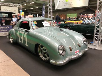 Een groene vintage sportwagen met het nummer "74" te zien op de indoor autoshow Antwerp Classic Salon 2020.