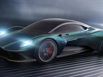 Futuristische Aston Martin-sportwagen in beweging op een dynamische achtergrond.