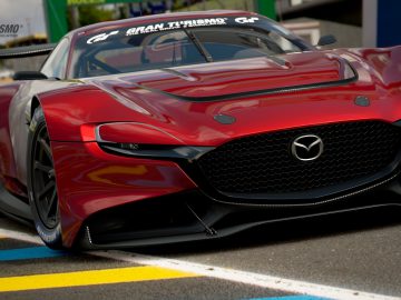 Een rode Mazda RX-Vision GT3 Concept-sportwagen met gran turismo-branding prominent weergegeven.