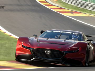 Een Mazda RX-Vision GT3 Concept racet op een circuit met een andere auto vlak daarachter, beide vastgelegd in een snelle, dynamische opname.