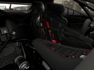 Binnenaanzicht van een Mazda RX-Vision GT3 Concept-racewagen met een gedetailleerd dashboard, raceharnas en rolkooi.
