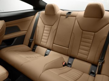 Luxe BMW 4 Serie Coupé-interieur met met leer beklede achterbank en moderne designelementen.