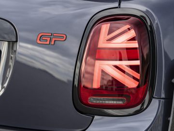 Close-up van het achterlicht van een MINI John Cooper Works GP 2020-auto met een Union Jack-ontwerp naast een "gp"-badge.