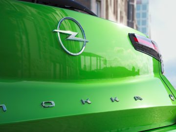 Close-up van het achterembleem en de modelnaam van een groene Opel Mokka.