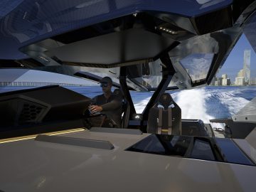 Een persoon die de Tecnomar voor Lamborghini 63 bestuurt, met een hightech dashboard en uitzicht op de oceaan.