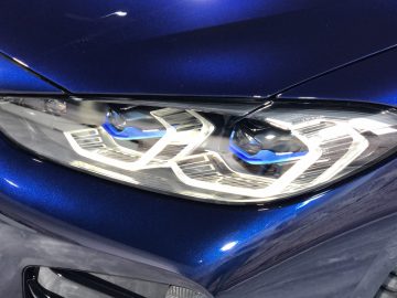 Close-up van de koplamp van een BMW 4 Serie Coupé met ingewikkelde designdetails.