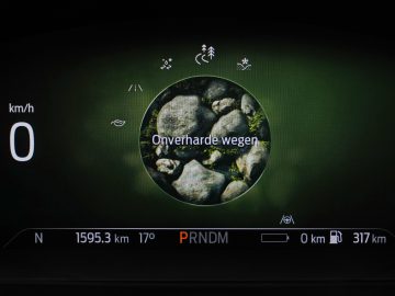 Digitaal autodisplay in de Ford Explorer PHEV met nulsnelheid, een modus voor "onverharde wegen" (onverharde wegen) en verschillende voertuigstatusindicatoren.