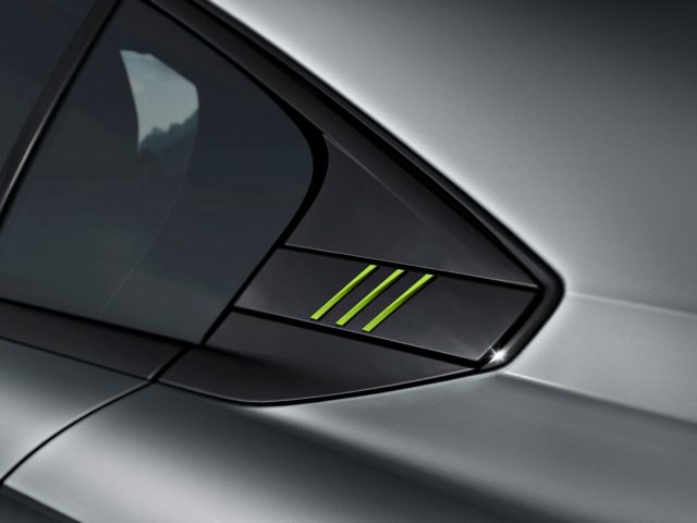 Close-up van de zijspiegel van een Peugeot 508 met drie groen verlichte strepen op een grijs oppervlak.