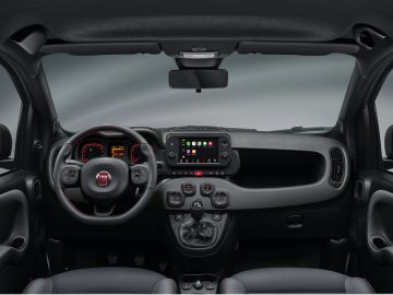 Binnenaanzicht van een Fiat Panda Sport met het stuur, het dashboard en de middenconsole met verschillende bedieningselementen en een digitaal display.