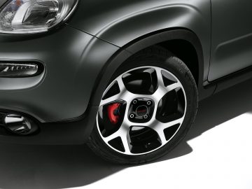Close-up van een lichtmetalen velg van een Fiat Panda Sport met een rode remklauw zichtbaar door de spaken.