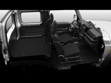 Binnenaanzicht van de Suzuki Jimny Professional met een open deur, twee voorstoelen, dashboard en stuur, met een grijs kleurenschema.