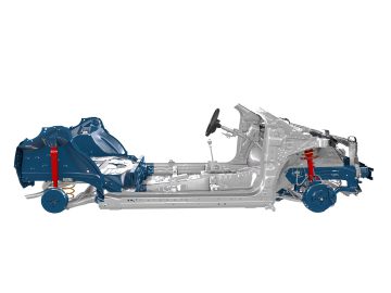 Zijaanzicht van een Toyota Aygo-chassisframe, met de interne structurele componenten, waaronder het stuur, het ophangingssysteem en de gemarkeerde voor- en achterkant.