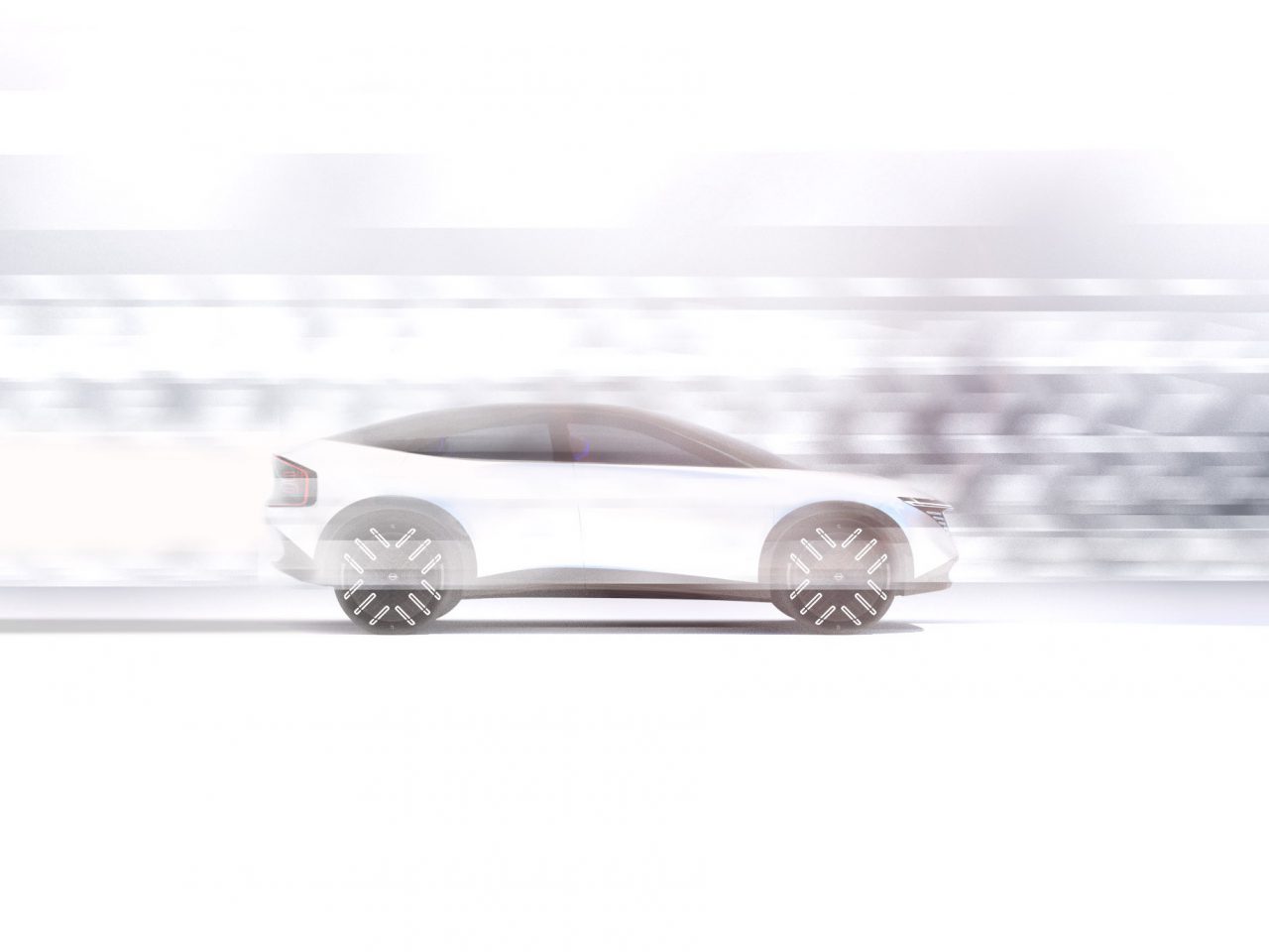 Een witte Nissan-auto in beweging, vastgelegd met een bewegingsonscherpte-effect, die van links naar rechts rijdt.