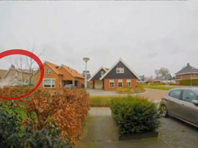 Een buurtstraat met meerdere huizen, geparkeerde auto's en een veilige laadpaal. Een rode cirkel markeert een van de huizen aan de linkerkant van de afbeelding.