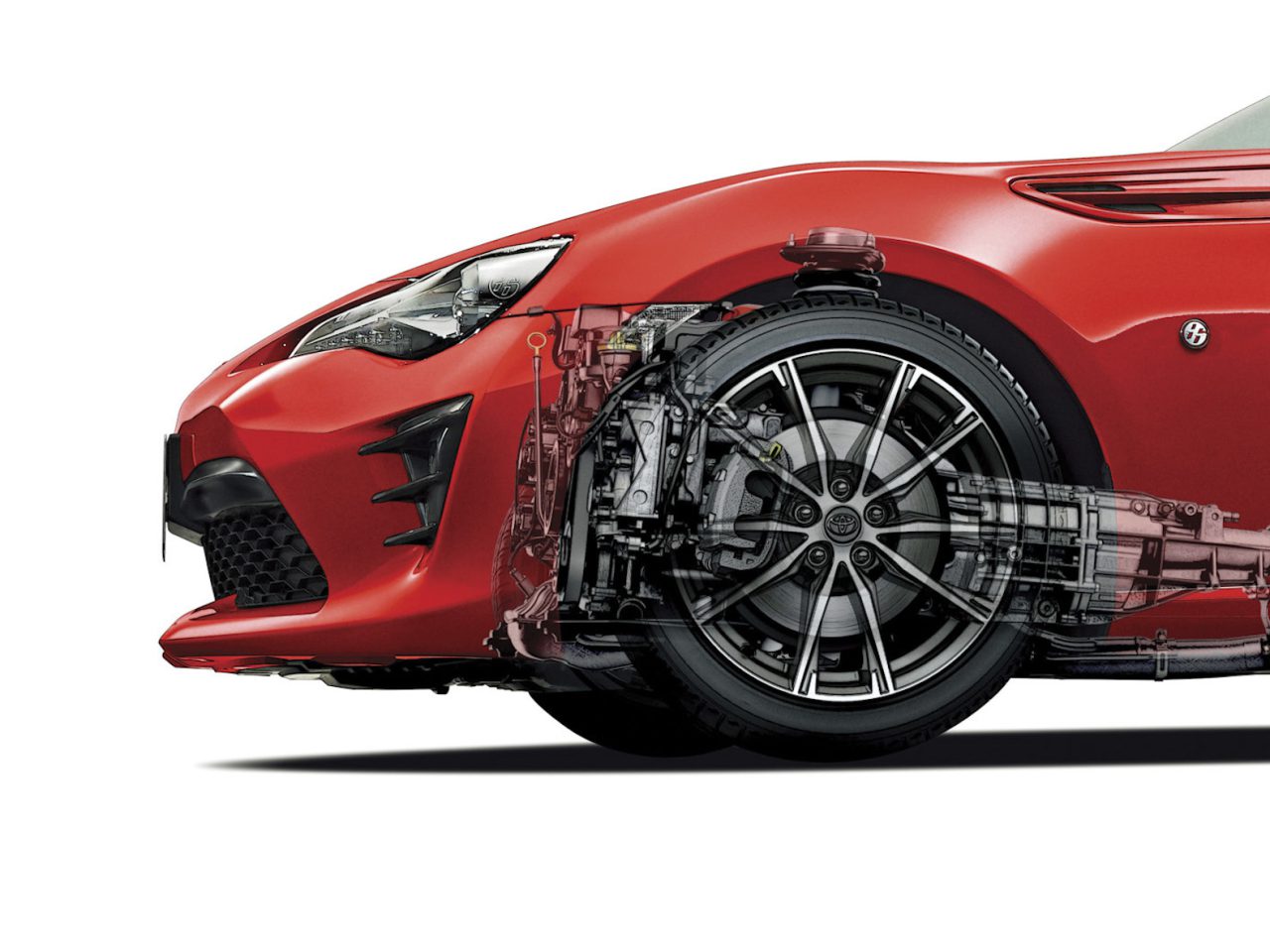 Een rode sportwagen met een transparante overlay die de voorwielophanging, aandrijflijncomponenten en details van het remvloeistofsysteem zichtbaar maakt.