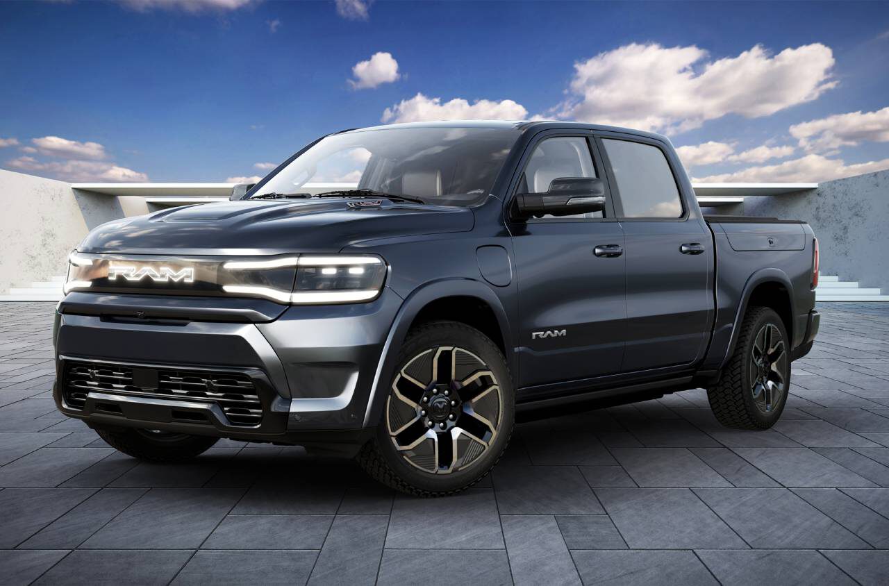 Een grijze RAM-pick-up staat geparkeerd op een betegeld oppervlak met een helderblauwe lucht en verspreide wolken op de achtergrond.