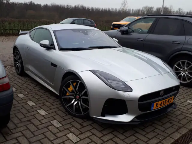 A silver Jaguar F-Type SVR sports car parked on the street, spotted.