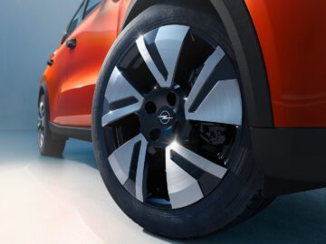 Close-up of an alloy rim of an SUV with a blue background with color gradient.