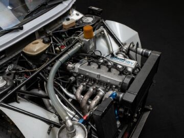 Close-up of a car engine with various components and labels visible, including a 