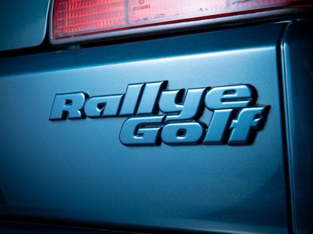 Close-up of the 'Rallye Golf' emblem on the back of a blue car, near the taillight: a perfect snapshot for any motorsport coverage.